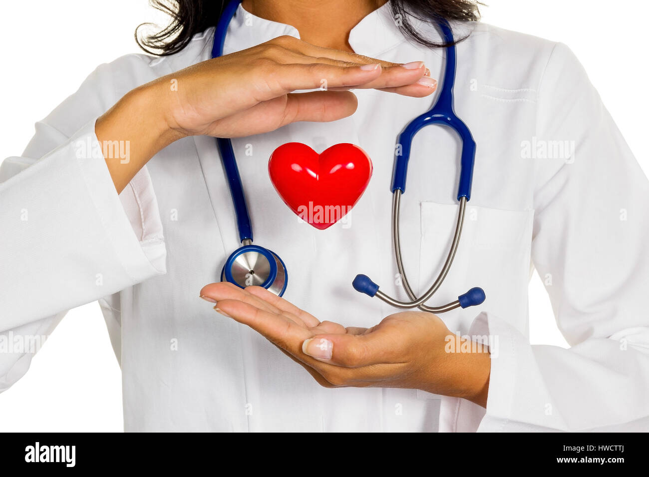 A young doctor (internist) holds a heart symbolically in the hand., Eine junge Ärztin (Internistin) hält ein Herz symbolisch in der Hand. Stock Photo