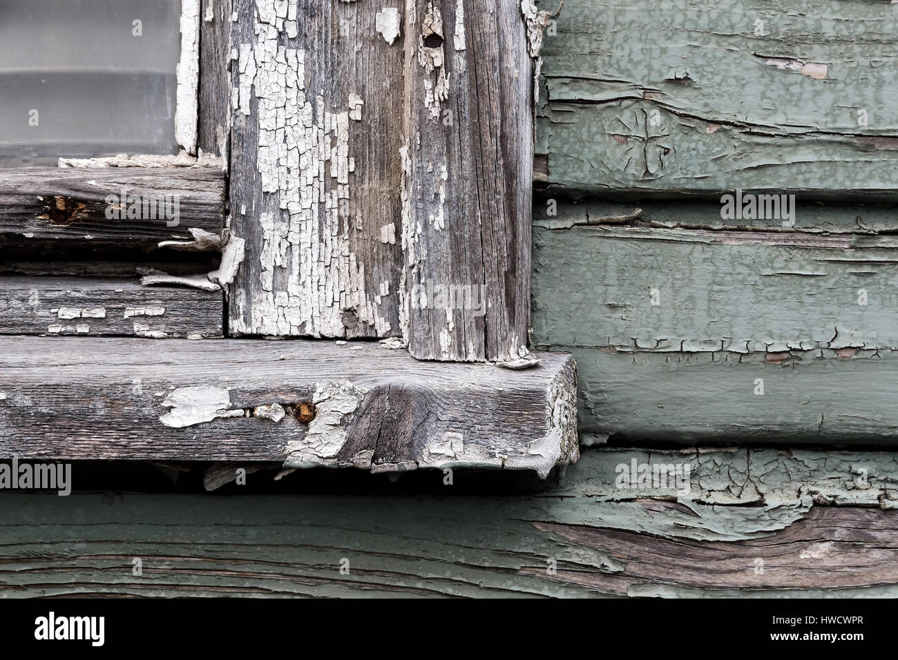 Old person, flaky colour by a wooden window. Weather, Alte, abgeblätterte Farbe bei einem Holzfenster. Witterung Stock Photo