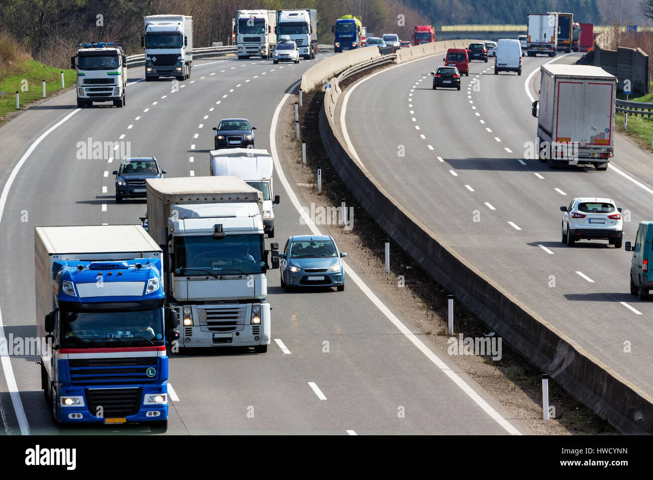 Trucks on the highway. Transport on the street for goods., Lastwagen auf der Autobahn. Transport auf der Straße für Güter. Stock Photo