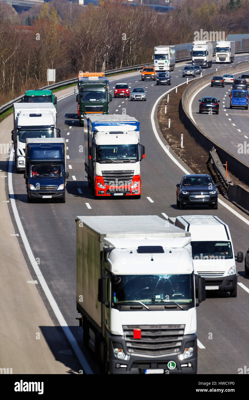 Trucks on the highway. Transport on the street for goods., Lastwagen auf der Autobahn. Transport auf der Straße für Güter. Stock Photo