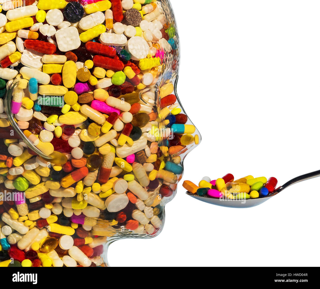A head of glass with many tablets full. Symbolic photo for drugs, abuse and tablet addiction., Ein Kopf aus Glas mit vielen Tabletten gefuellt. Symbol Stock Photo