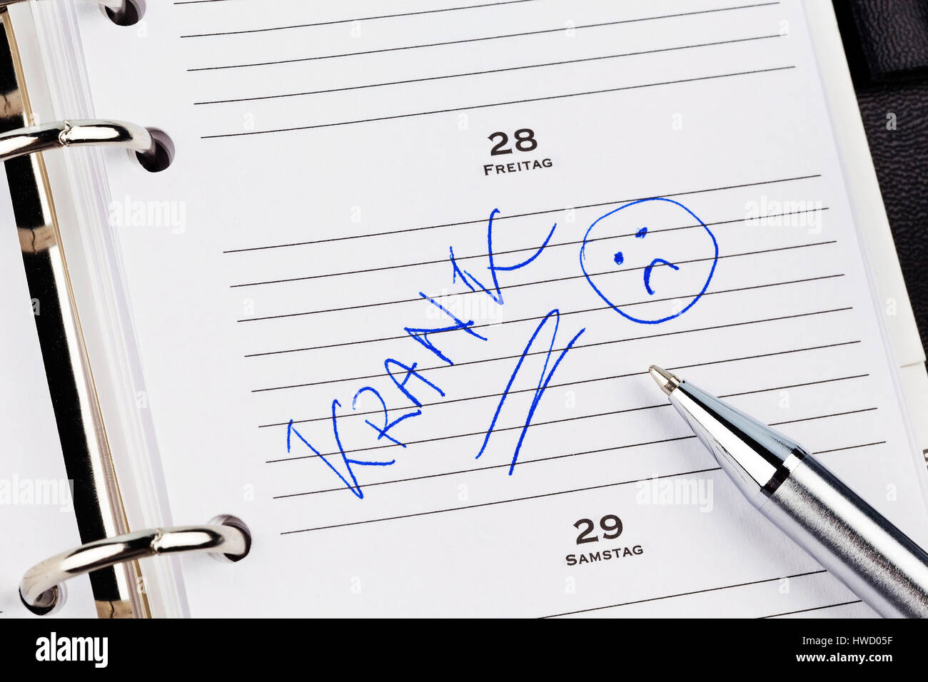 An appointment is put down in a calendar: Ill, Ein Termin ist in einem Kalender eingetragen:  Krank Stock Photo