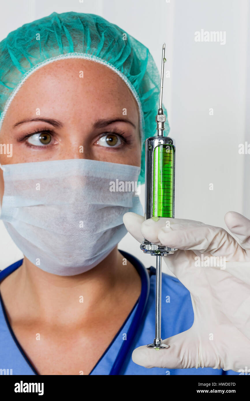 A nurse or doctor in clothes OP before an operation. Symbolic photo for work in the hospital., Eine Krankenschwester oder Aerztin in OP Kleidung vor e Stock Photo