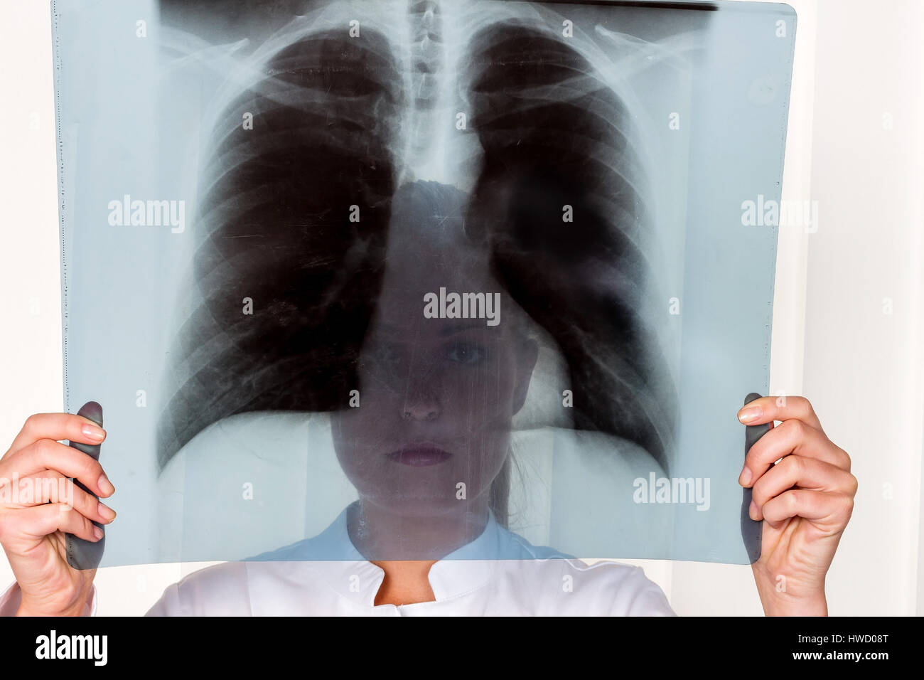 A nurse or doctor in clothes OP before an operation. Symbolic photo for work in the hospital, Eine Krankenschwester oder Aerztin in OP Kleidung vor ei Stock Photo