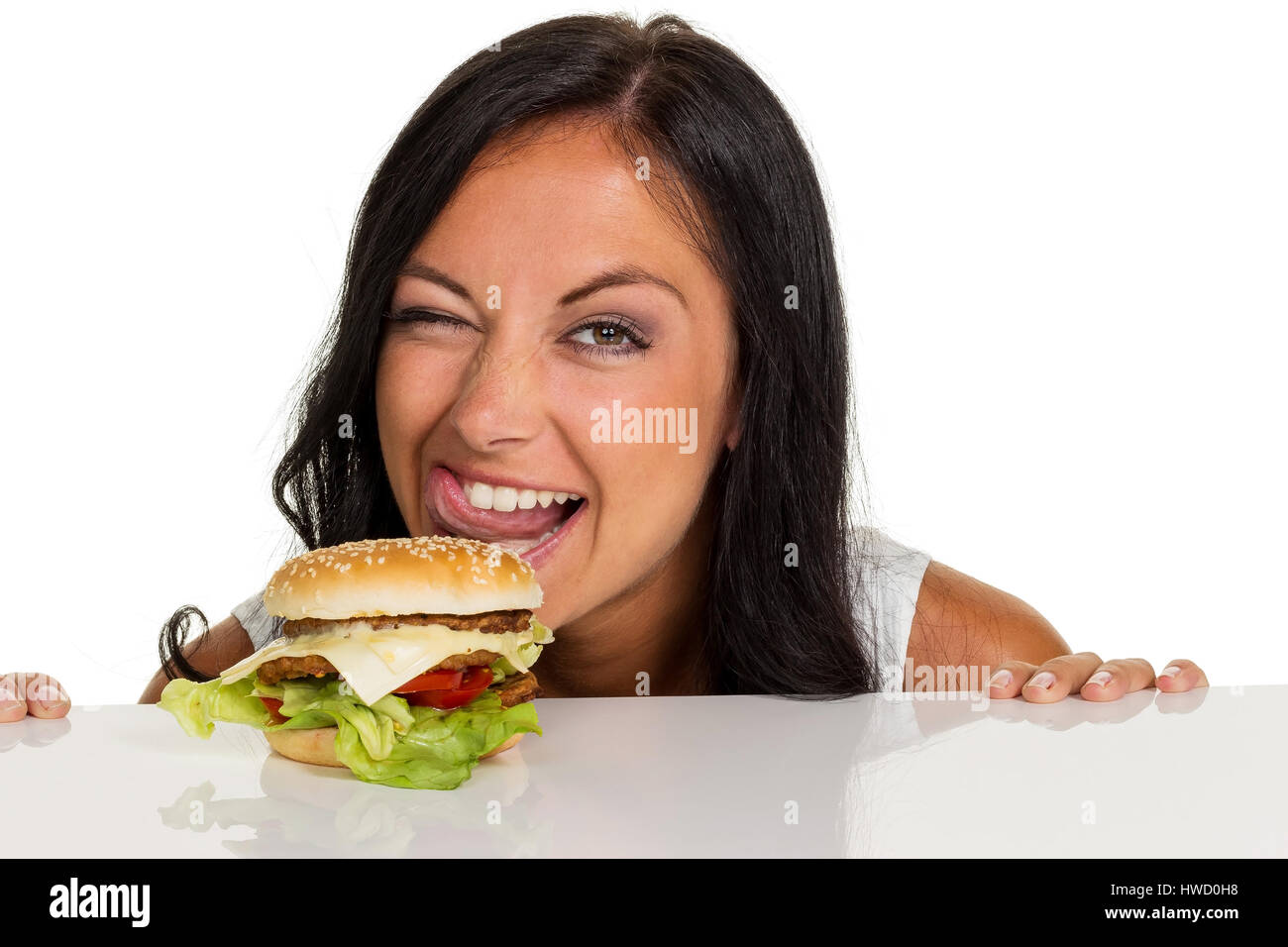 A young woman with a hamburger. Almost food and quick kitchen, Eine ...