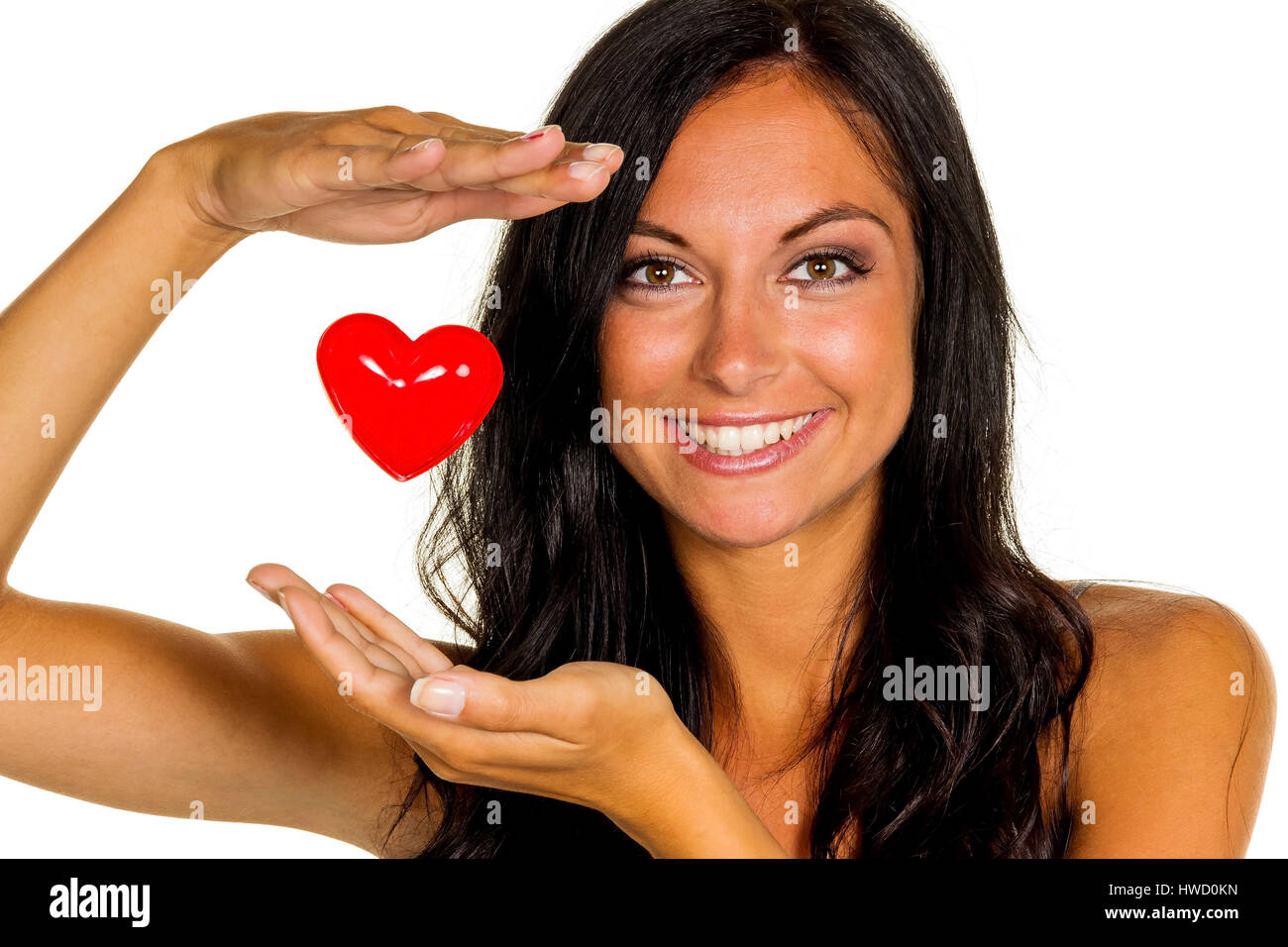 A young woman in love holds a heart in the hand, Eine verliebte junge Frau h‰lt ein Herz in der Hand Stock Photo