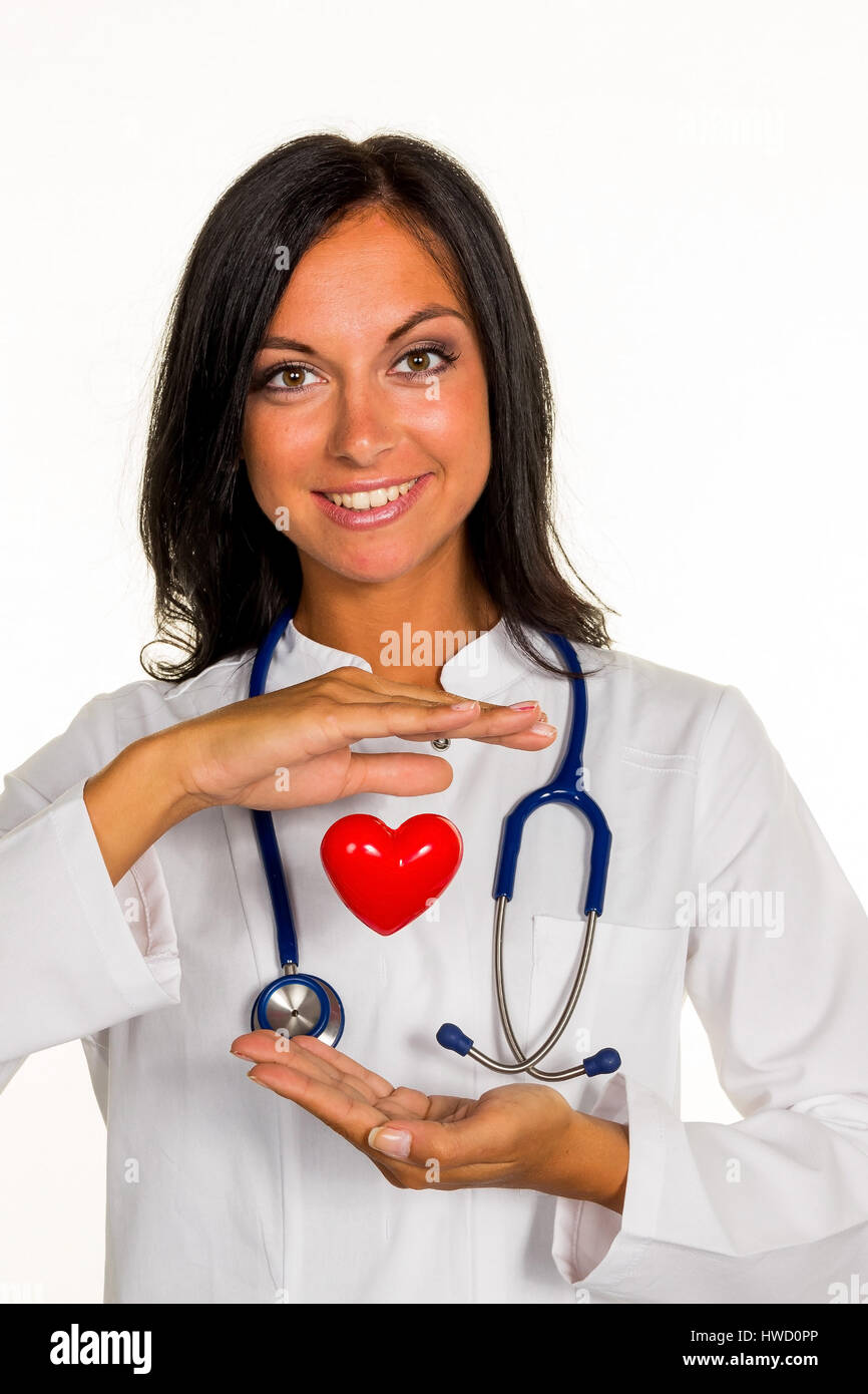 A young doctor internist holds a heart symbolically in the hand., Eine junge ƒrztin (Internistin) h‰lt ein Herz symbolisch in der Hand. Stock Photo