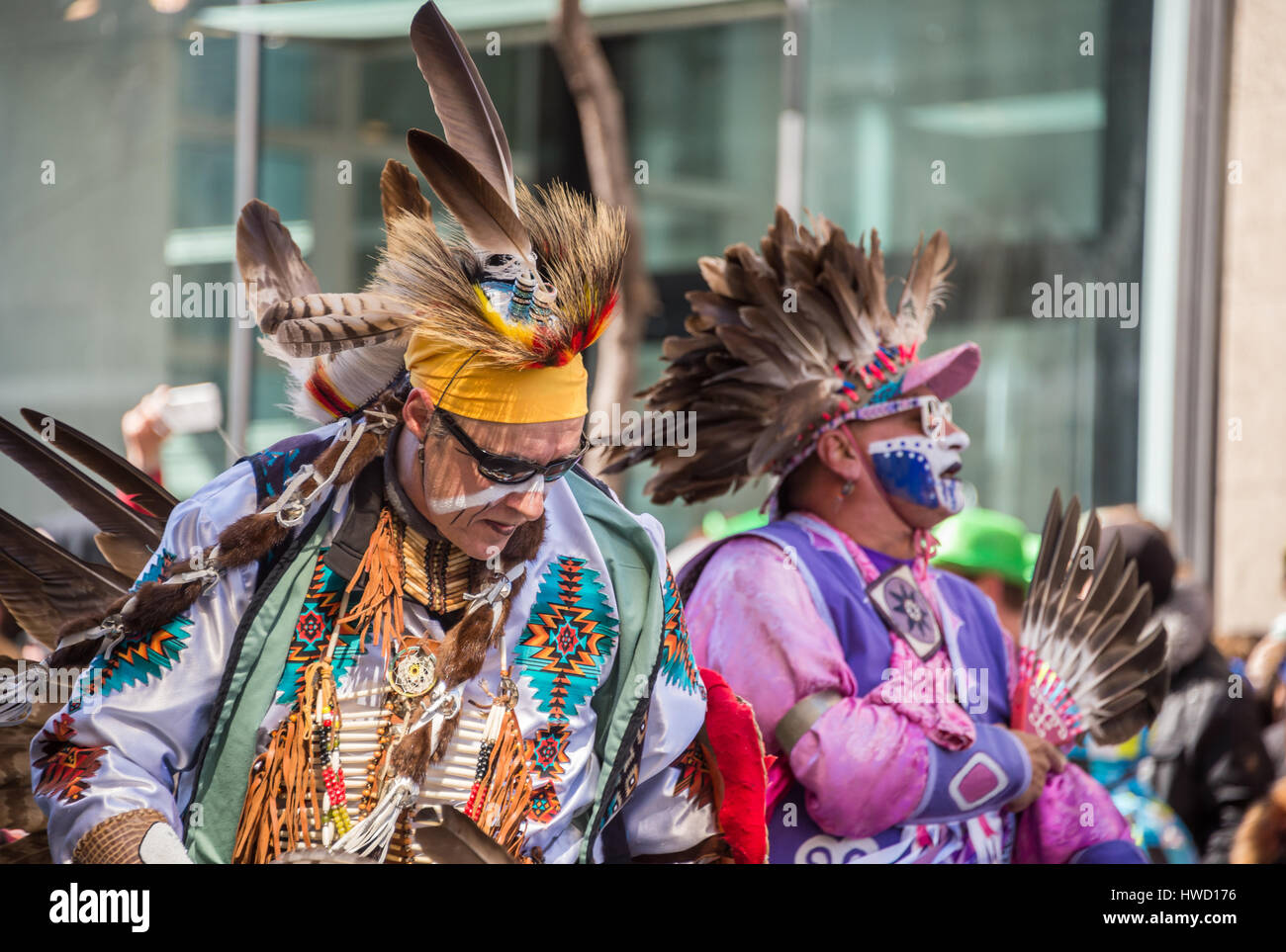Montreal, Canada - 19 March 2017: Two Kahnawake Mohawks do a traditional dance as they take place in the St. Patrick's parade. Stock Photo