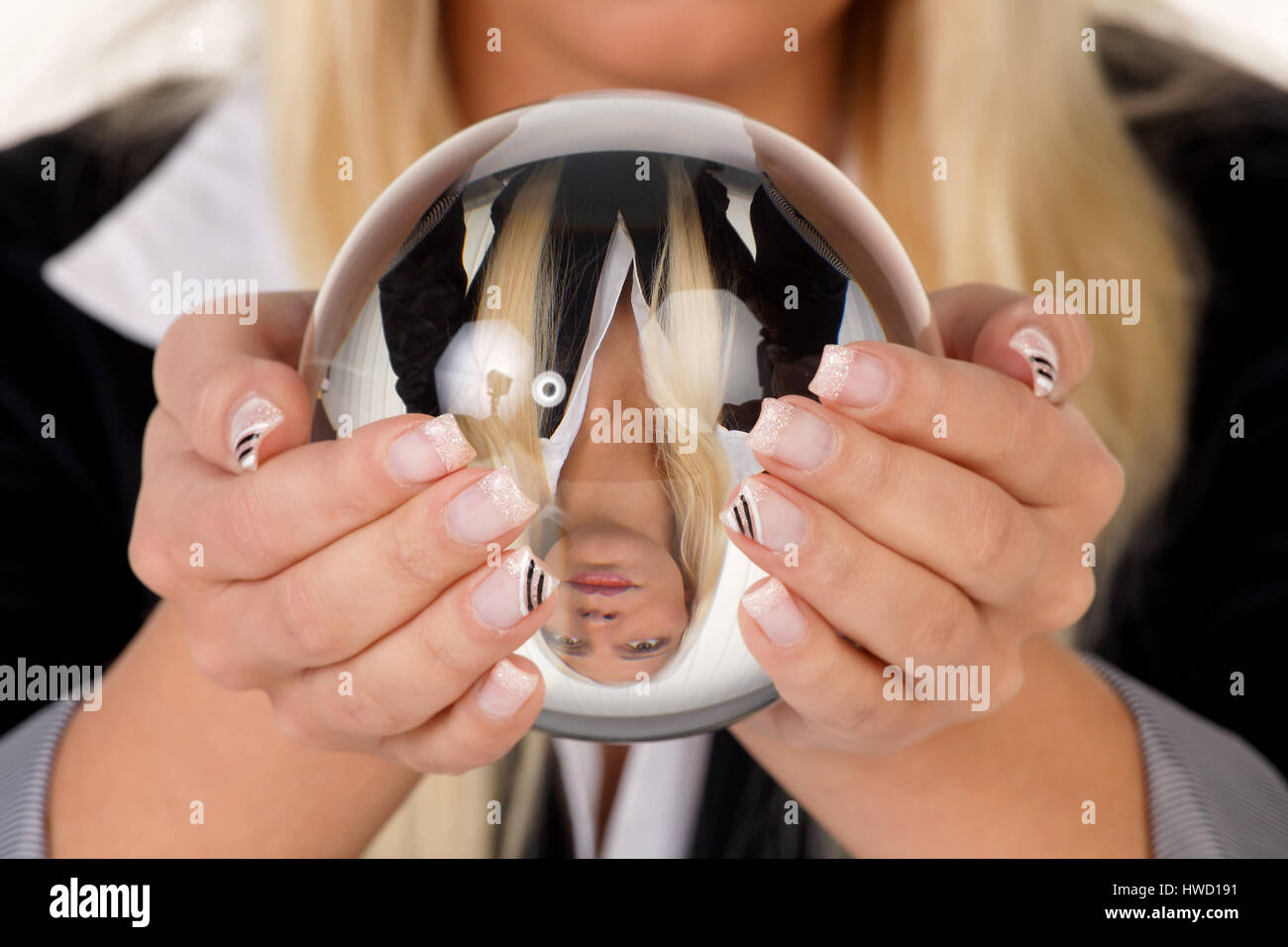 Young woman interprets the future from a crystal ball in her hands, Junge Frau deutet die Zukunft aus einer Kristallkugel in ihren H‰nden Stock Photo