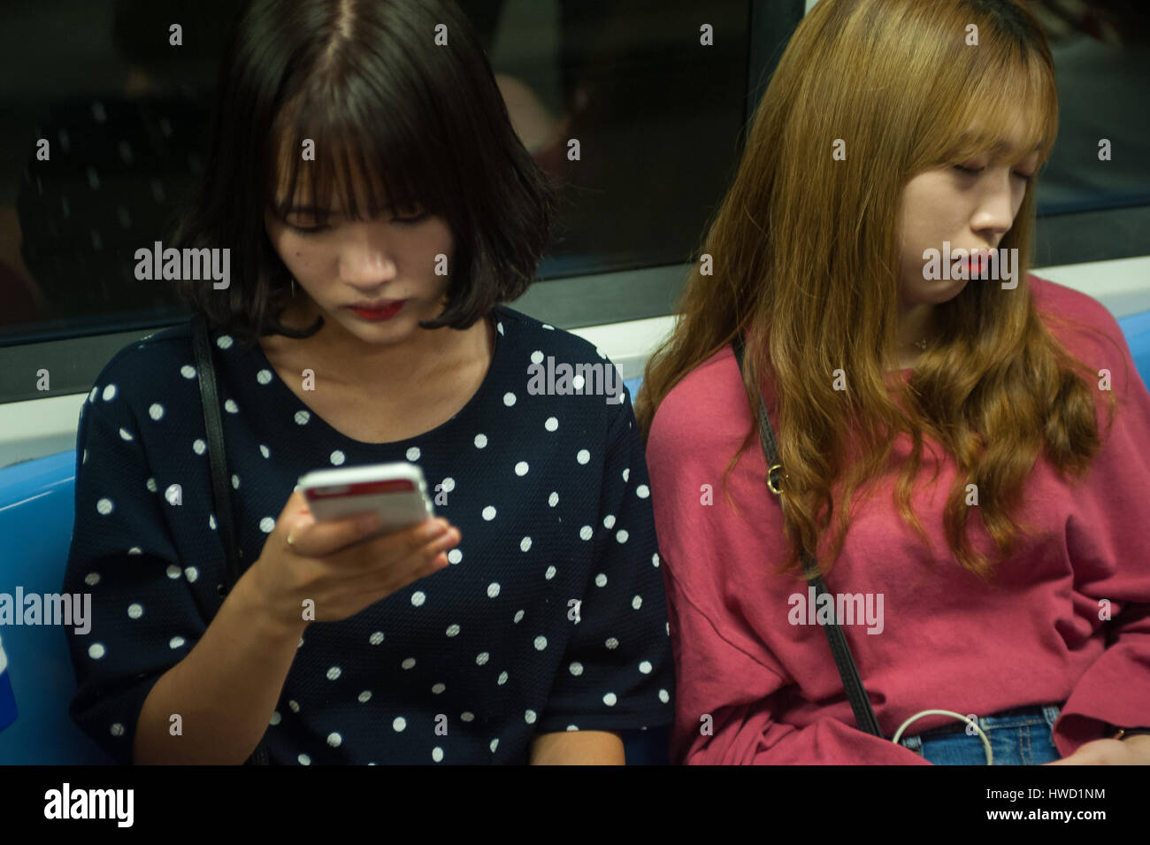 22.09.2016, Singapore, Republic of Singapore - Two young women on a metro in Singapore. Stock Photo