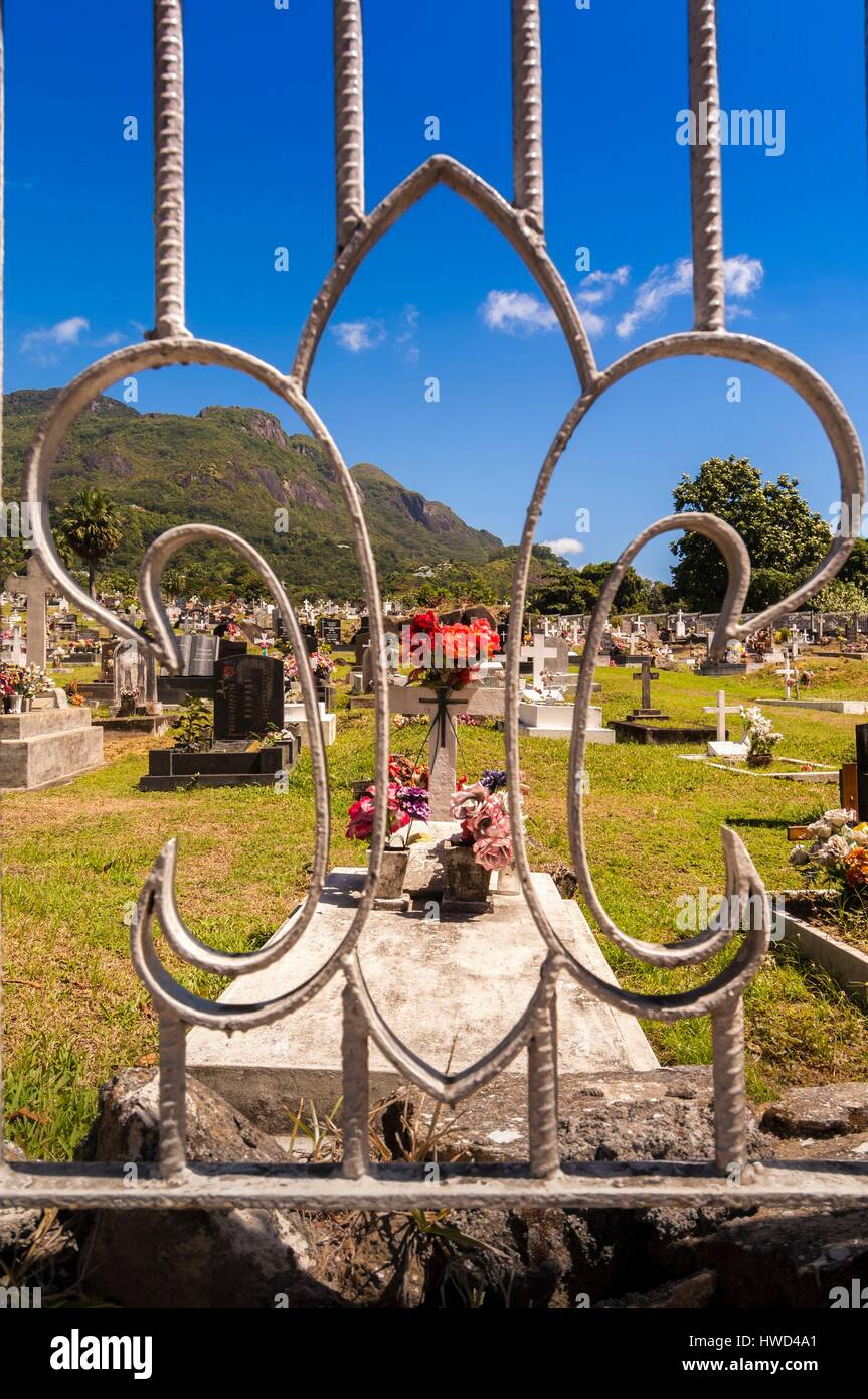 Seychelles, Mahe island, Victoria cemetery through a gate with lily flower, Morne Seychellois background Stock Photo