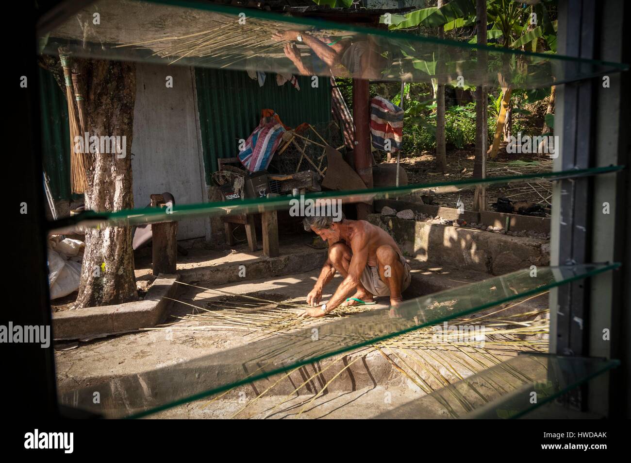 Seychelles, Mahe Island, Mont Fleuri, fisherman braiding a fishing trap ...