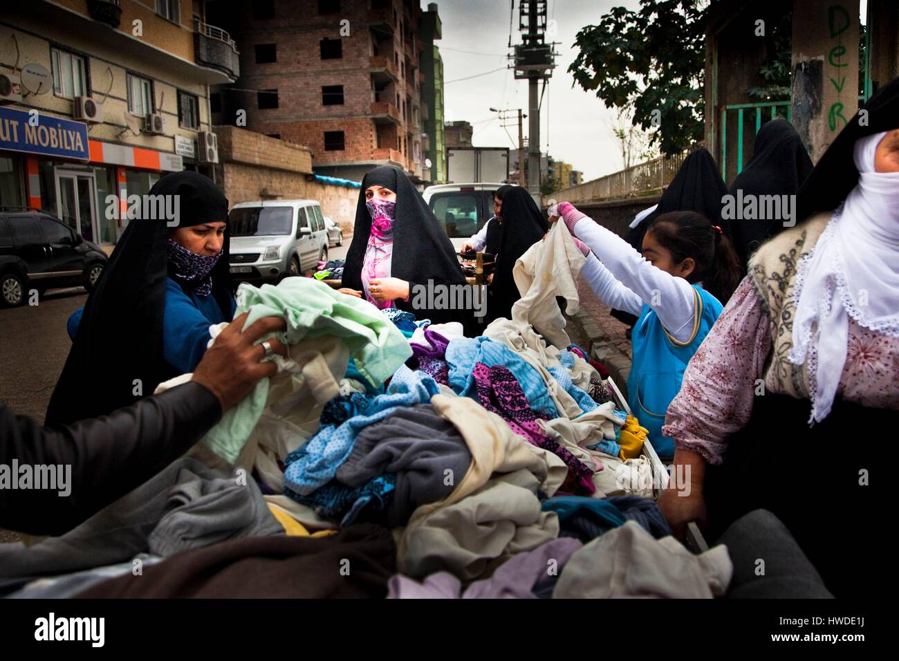 Turkey, South Eastern Anatolia, Sirnak Province, Cizre, women in chador buying clothes in a street market Stock Photo