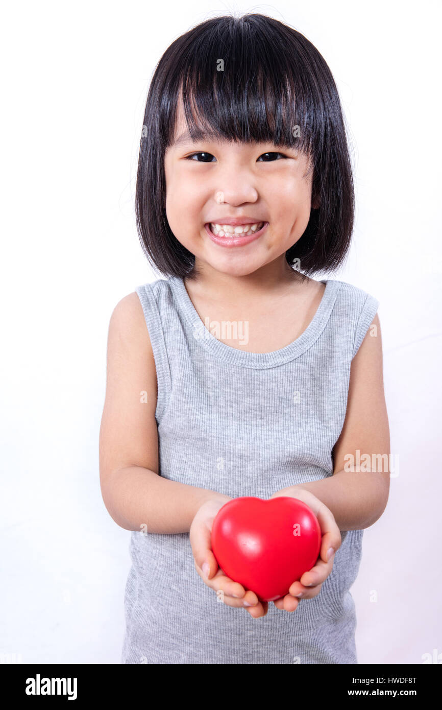 Asian Little Chinese Girl Holding Red Heart in isolated White