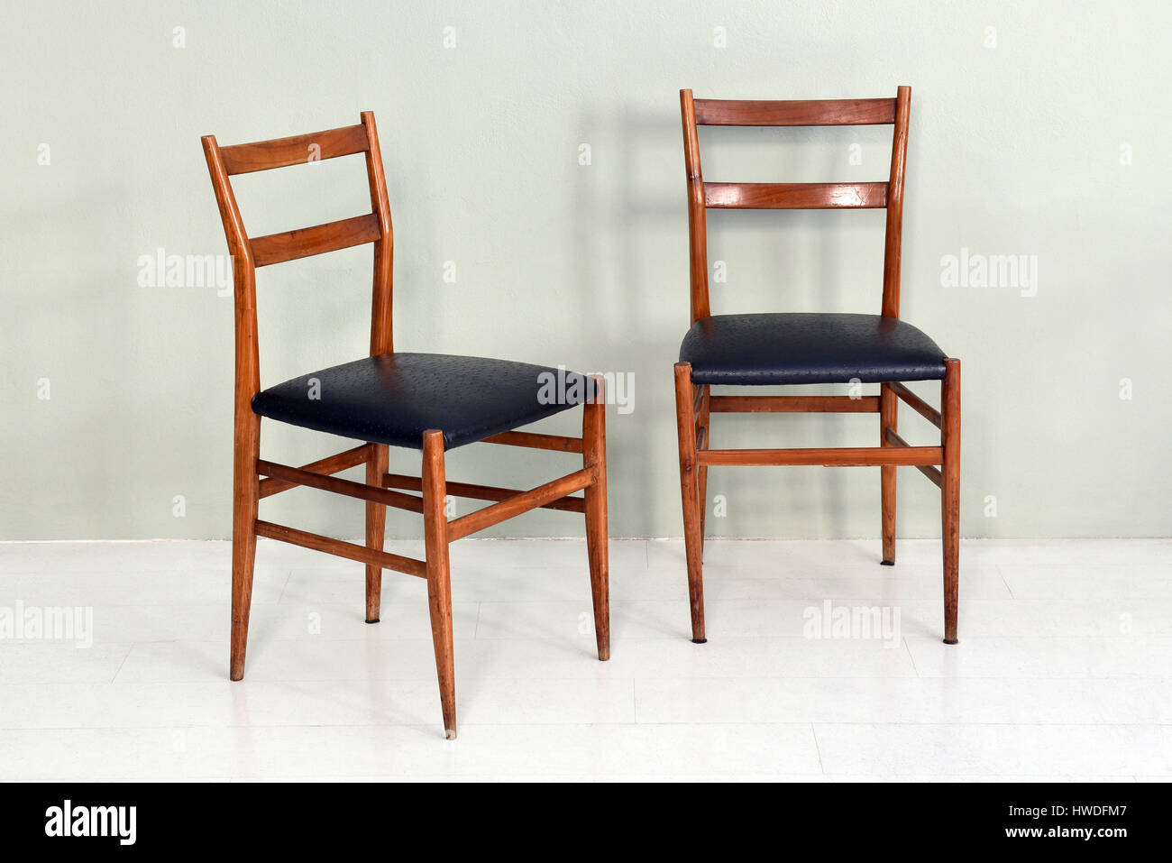 Still Life of Pair of Vintage Antique Kitchen Chairs with Wood Legs and