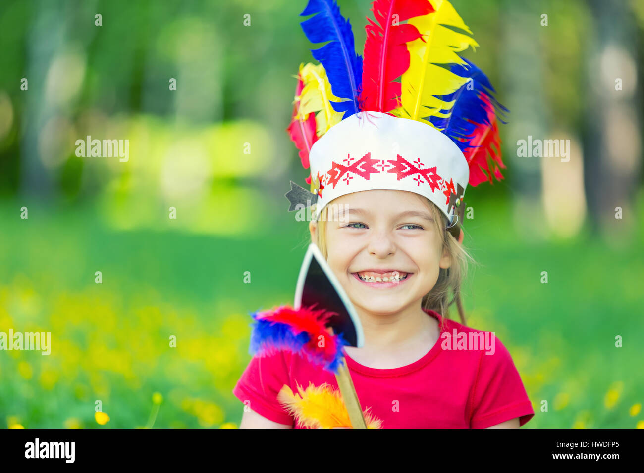 little funny girl playing native american Stock Photo