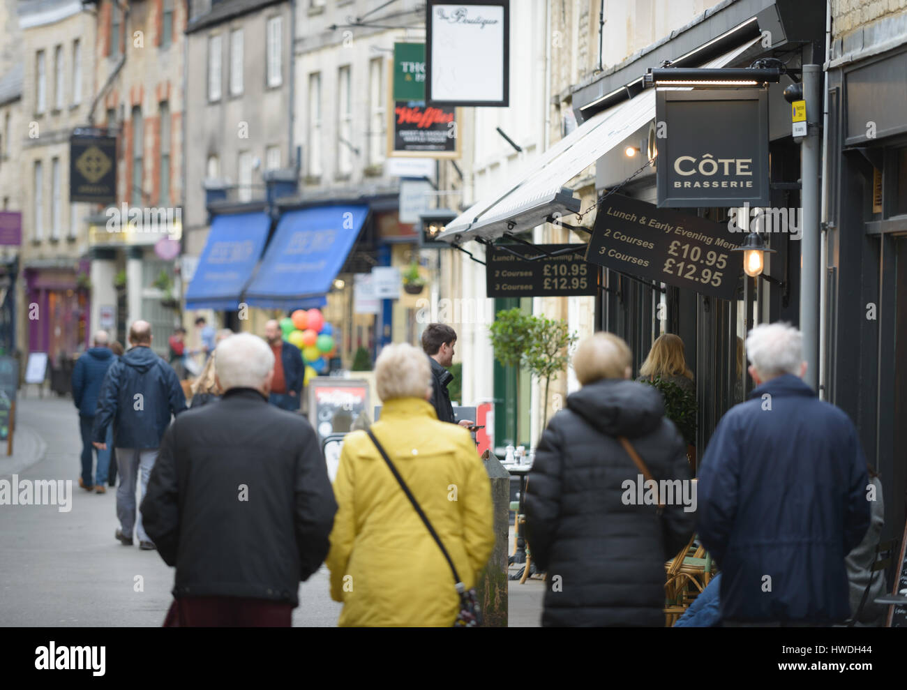 People walk down Black Jack Street, Cirencester in the Cotswolds, Gloucester, England, UK Stock Photo