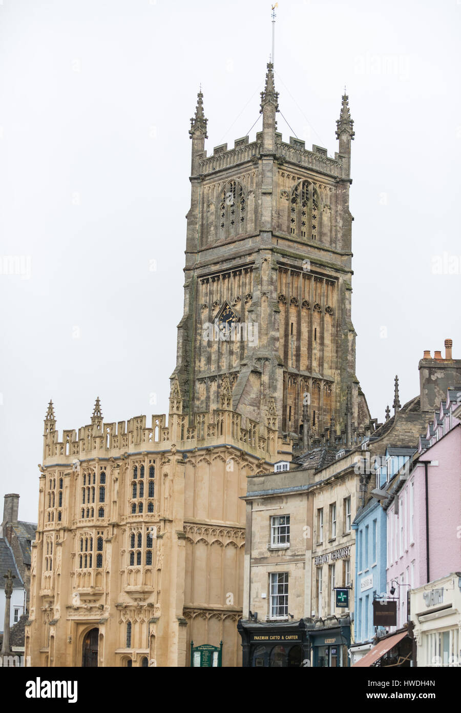 Colourful buildings and St John the Baptist parish church in Market Square, Cirencester in the Cotswolds, Gloucester, England, UK Stock Photo