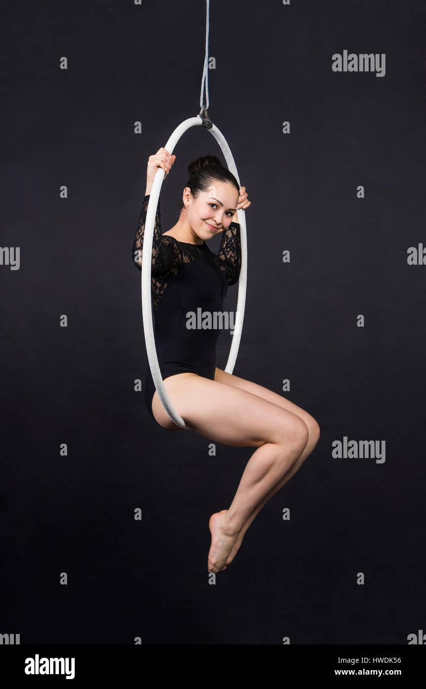 Aerial acrobat in the ring. A young woman performs the acrobatic ...