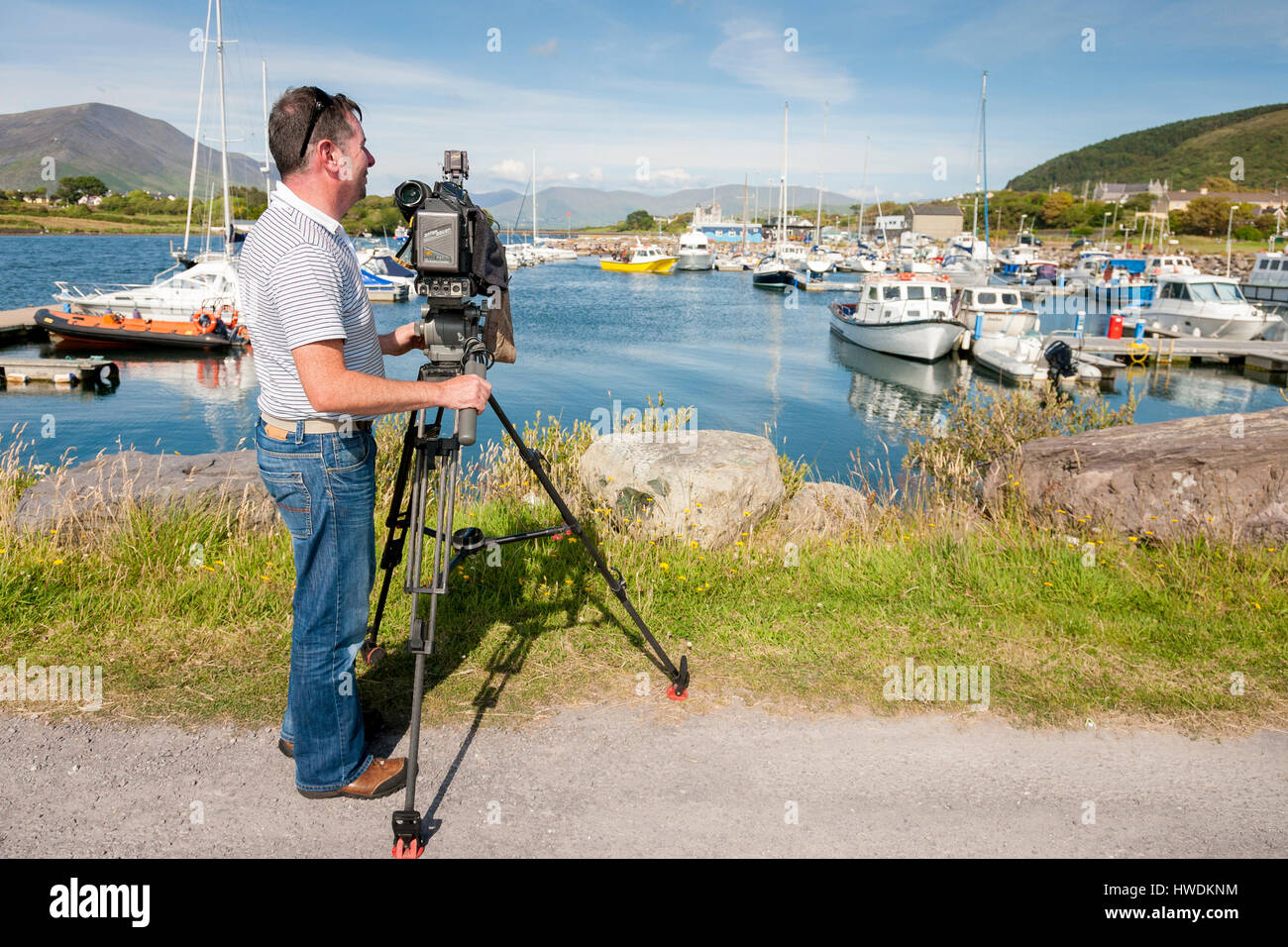 Television cameraman with Irish national broadcaster RTE on location in County Kerry, recording for a documentary programme. Stock Photo