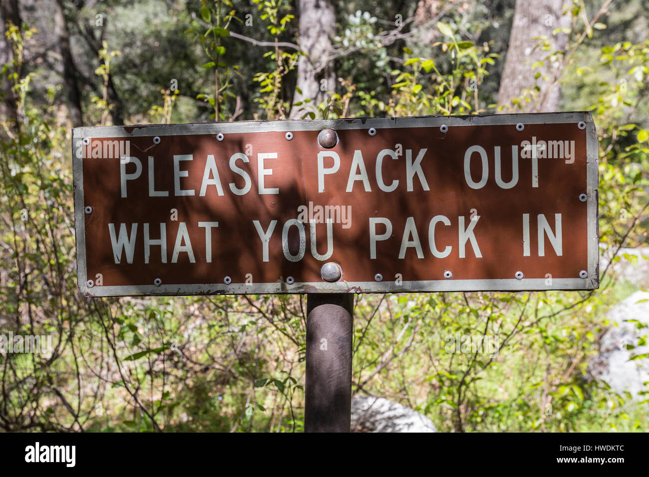 Please pack out what you pack in sign deep inside the Angeles National Forest in Southern California. Stock Photo