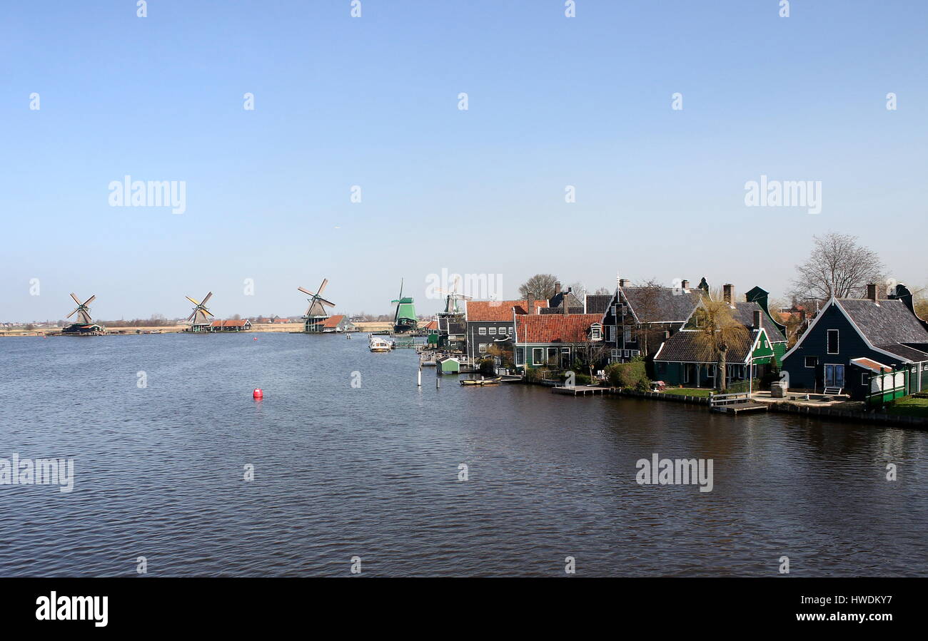 Traditional Dutch wooden houses at the village of Zaanse Schans, Zaandam / Zaandijk, Netherlands. Panorama of several 18th century windmills. Stock Photo