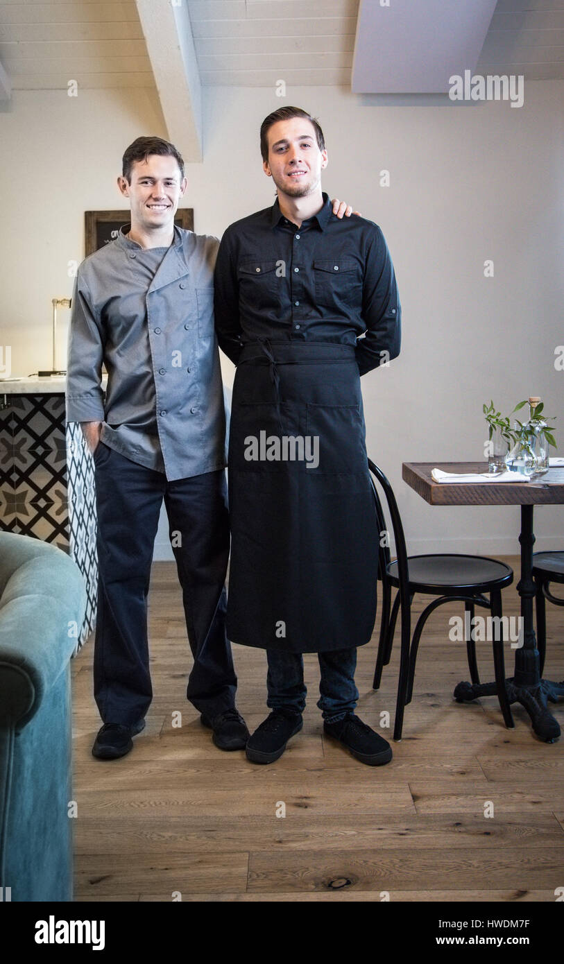 Portrait of two male waiters in restaurant Stock Photo