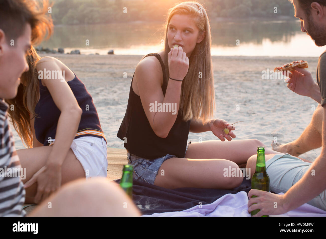 Group of friends drinking, enjoying beach party Stock Photo