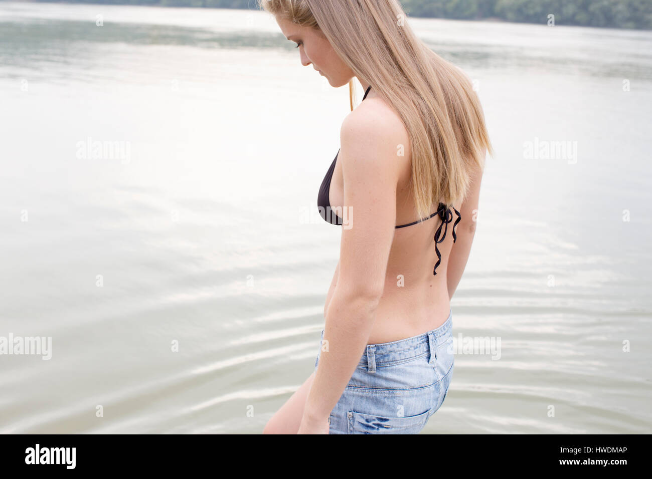 Woman contemplating by river Stock Photo