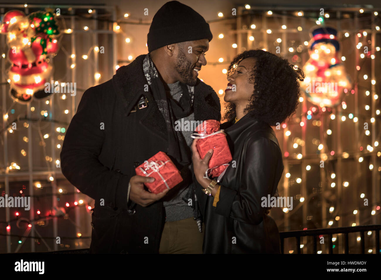 Romantic Couple Exchanging Christmas Gifts At Night New York Usa Romantic Couple Exchanging Christmas Gifts At Night New York Usa