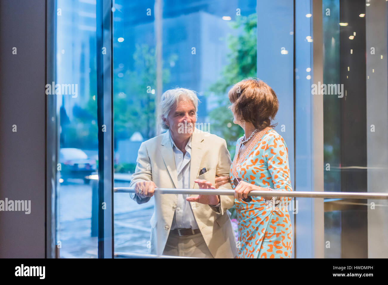 Senior couple using hotel revolving door Stock Photo