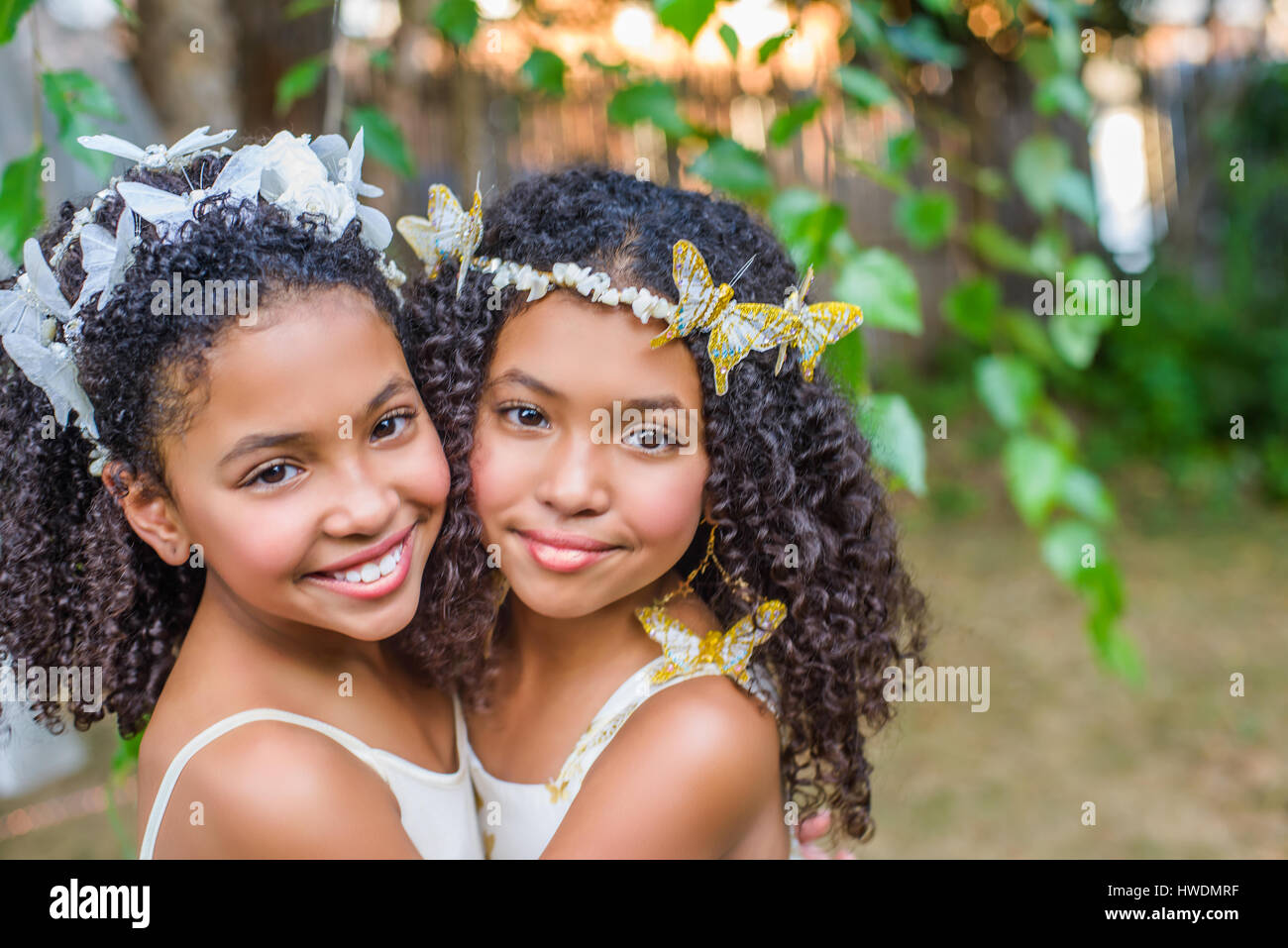 Portrait of two girls, wearing butterflies in hair Stock Photo