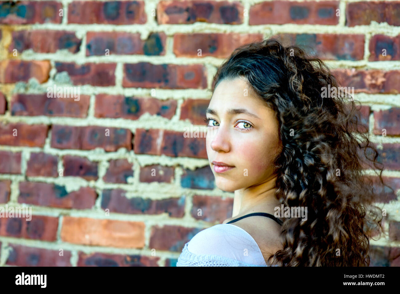 Portrait of teenage girl leaning against wall Stock Photo