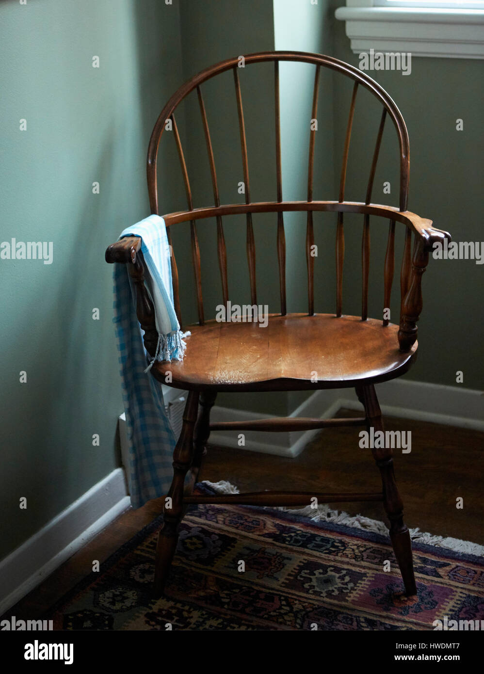 Empty chair in corner of room Stock Photo