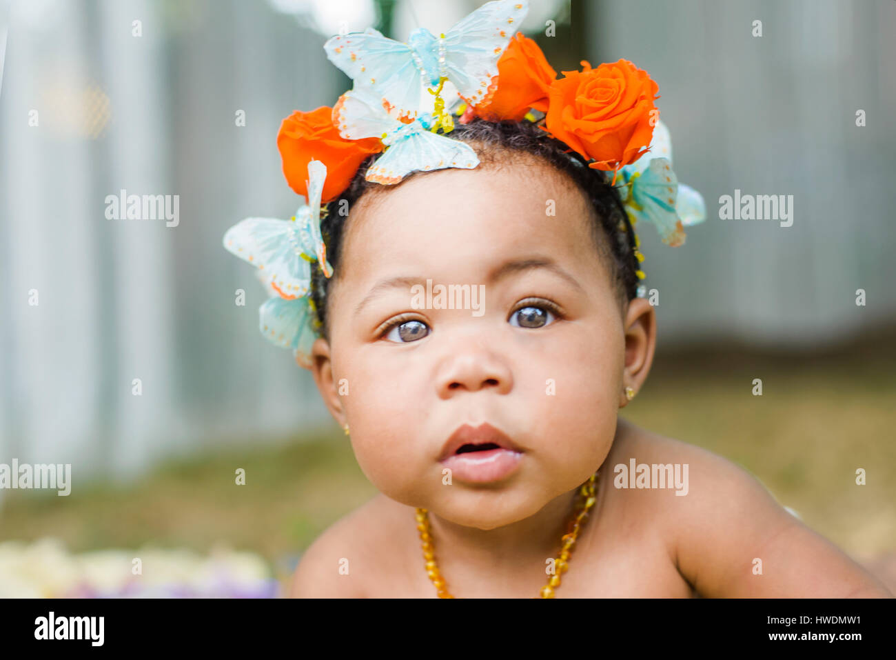 Portrait of baby girl wearing butterflies and flowers in her hair Stock Photo