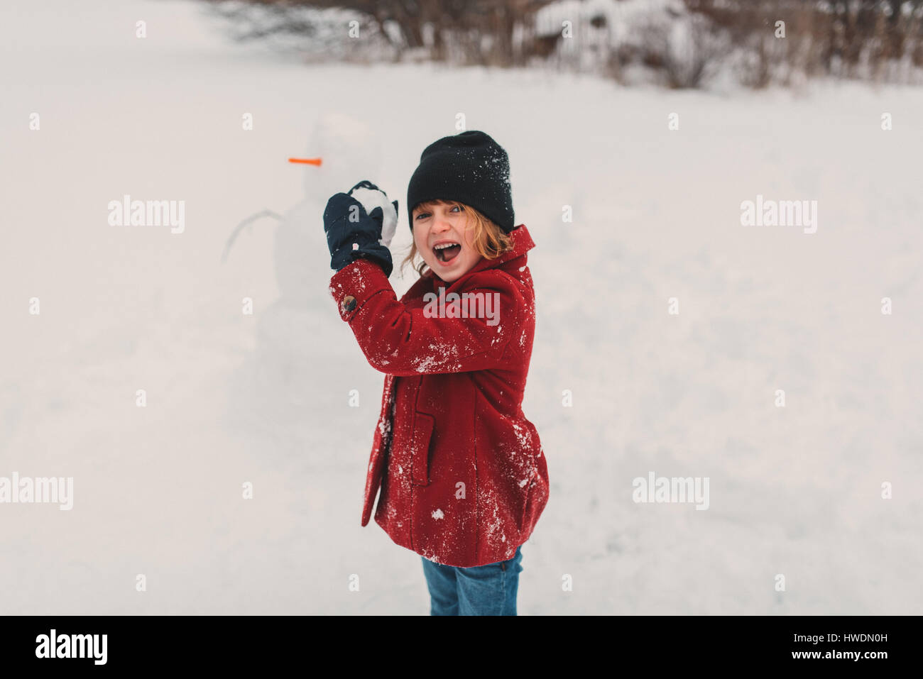 Girl getting ready to throw snowball Stock Photo