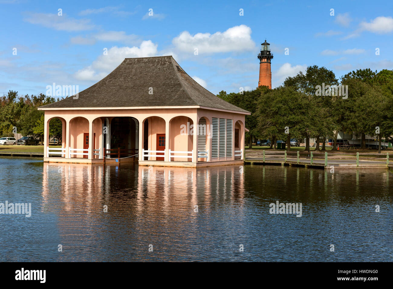NC00692-00...NORTH CAROLINA - Boat house at the Whalehead Club with Currituck Beach Light Station in the distance. Stock Photo