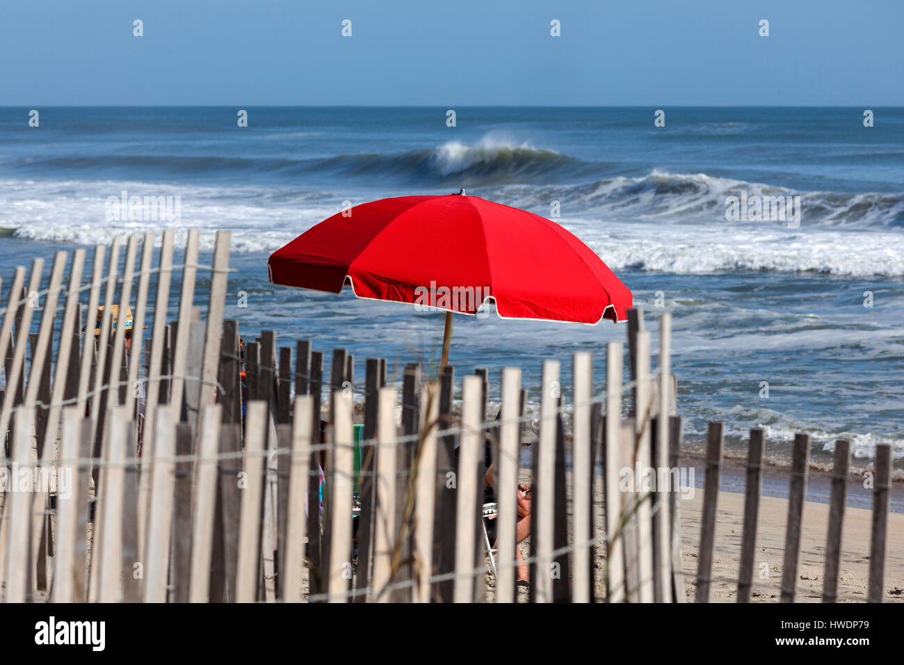 NC0074700...NORTH CAROLINA Red umbrella on the beach at wave Stock