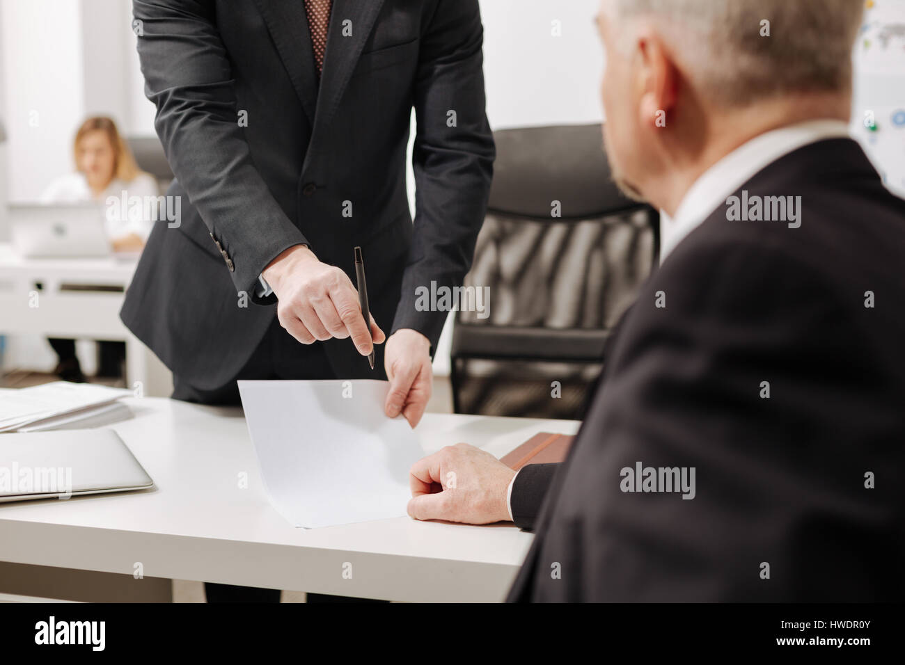 Mindful aged businessman signing the contract in the office Stock Photo
