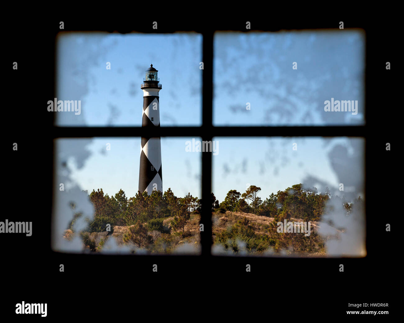 NC00869-00...NORTH CAROLINA - Cape Lookout Lighthouse viewed through a window on the South Core Banks in Cape Lookout National Seashore. Stock Photo