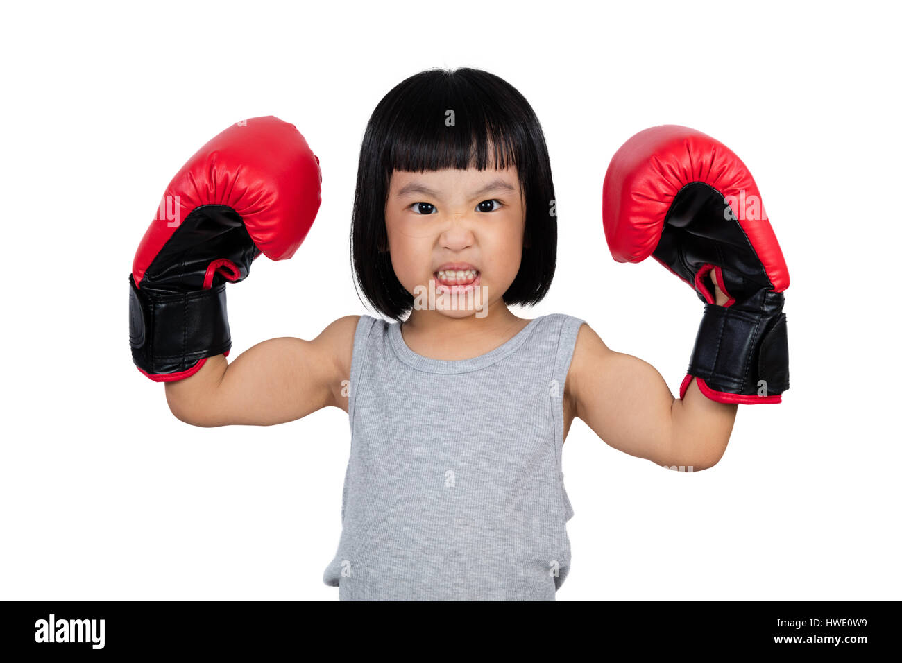 Chinese little girl wearing boxing glove showing power in isolated