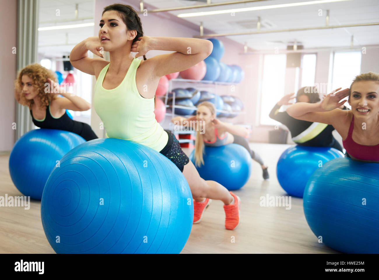 Girls using exercise ball on the class gym Stock Photo
