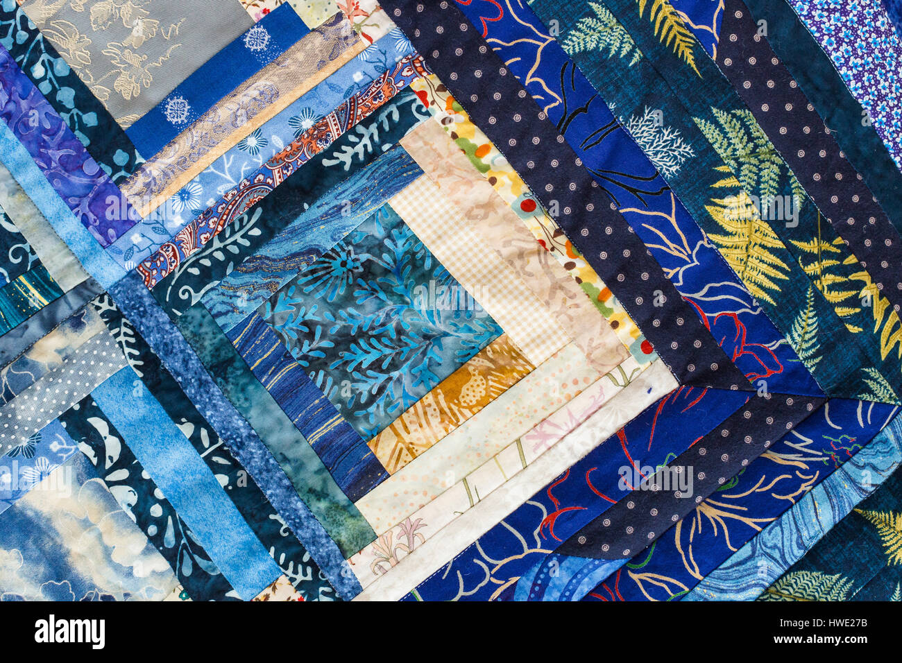 The colored patchwork quilt with blue geometry pattern. Part of