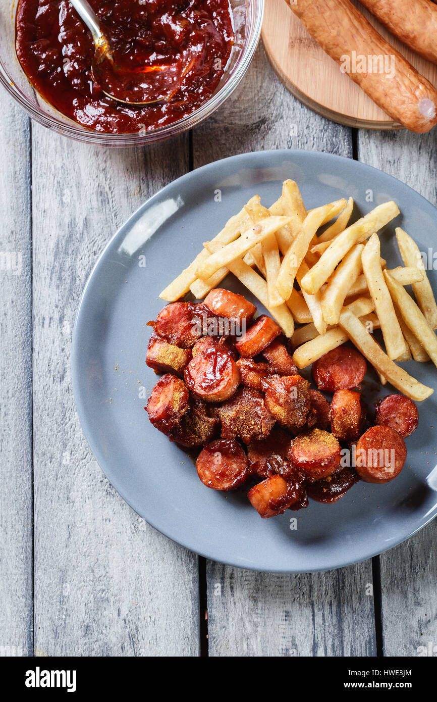 Traditional German currywurst - pieces of sausage with curry sauce and ...