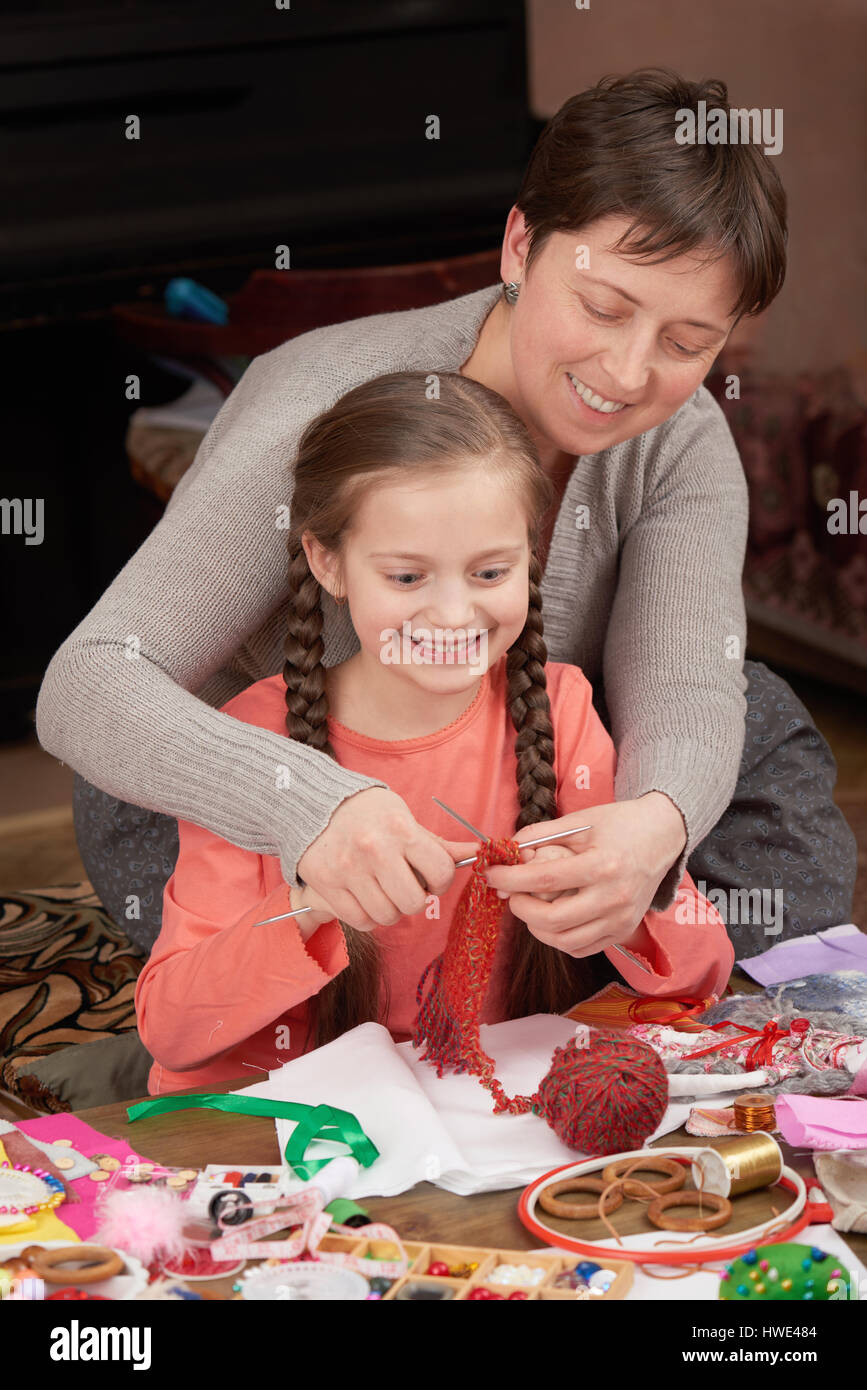 mother teaching daughter girl knit, job training, handmade and