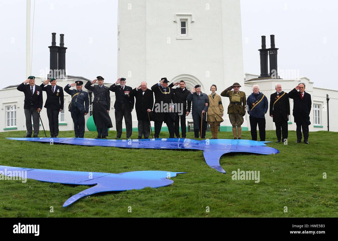 World War Two veterans, reenactors and dignitaries give a salute to Dame Vera Lynn during a tribute to her at South Foreland Lighthouse in Dover Kent to mark her 100th birthday. Stock Photo