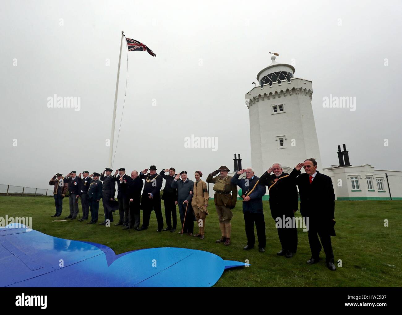 World War Two veterans, reenactors and dignitaries give a salute to Dame Vera Lynn during a tribute to her at South Foreland Lighthouse in Dover Kent to mark her 100th birthday. Stock Photo