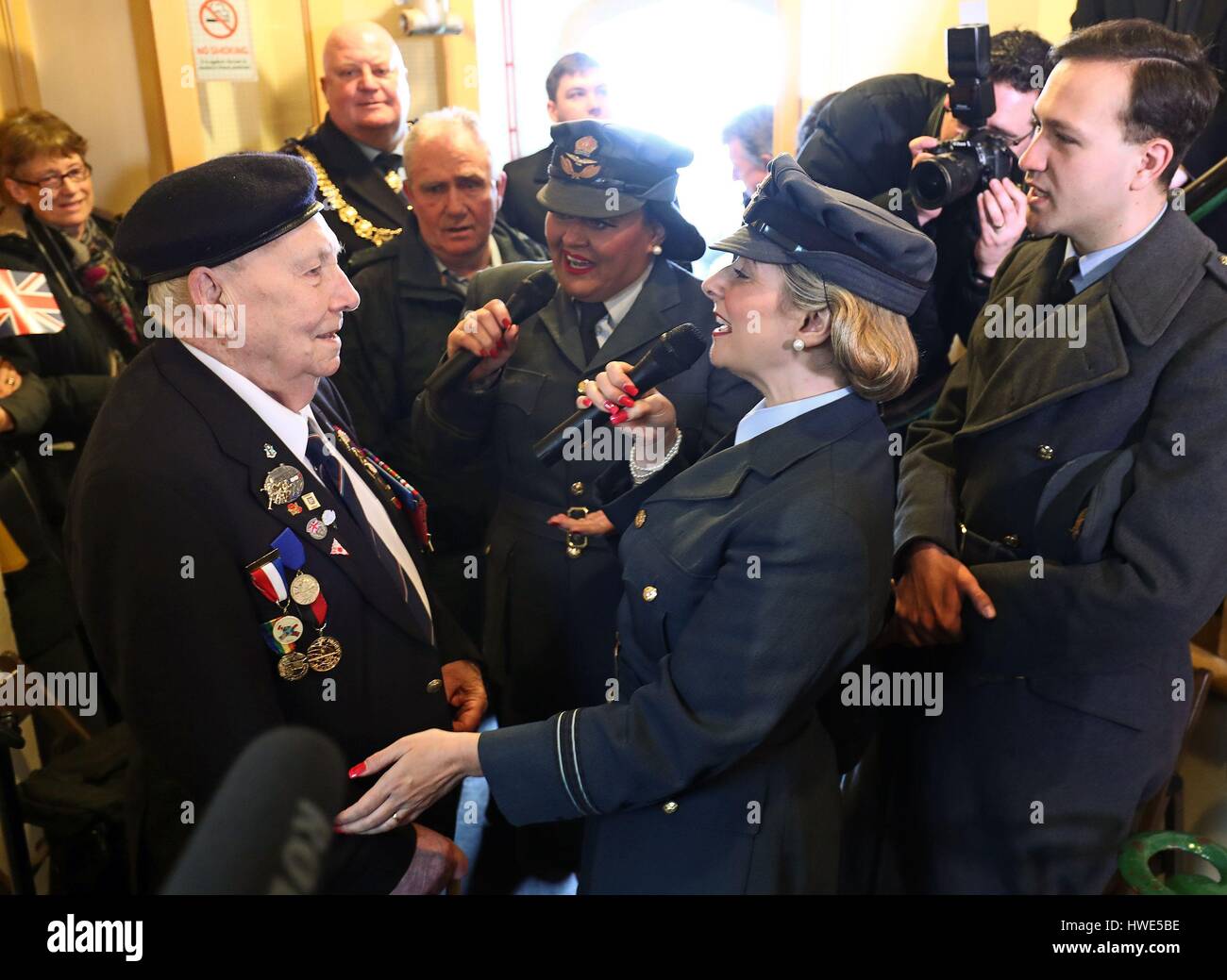 Learna Castle of Swingtime Sweethearts performs a song to World War Two veteran Robert Piper during a tribute to Dame Vera Lynn at South Foreland Lighthouse in Dover Kent to mark her 100th birthday. Stock Photo