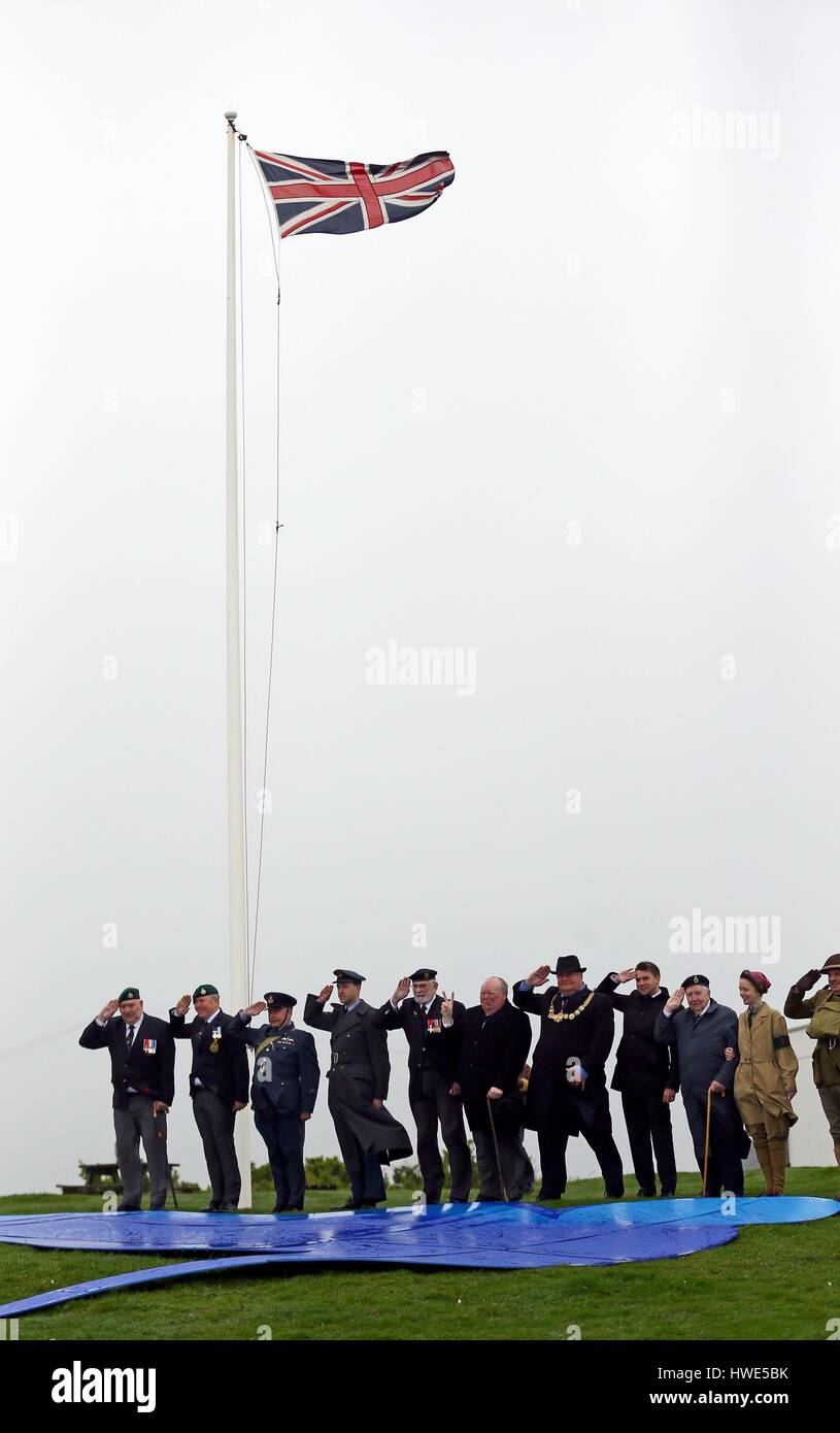 World War Two veterans, reenactors and dignitaries give a salute to Dame Vera Lynn during a tribute to her at South Foreland Lighthouse in Dover Kent to mark her 100th birthday. Stock Photo