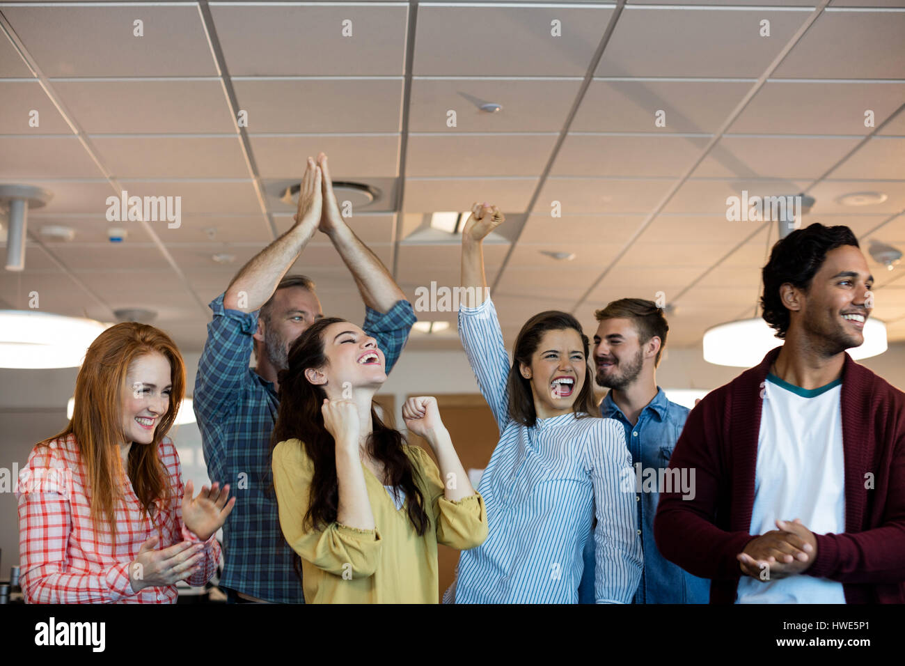 Happy creative business team celebrating success in office Stock Photo ...